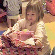 Madeleine removing the wrapping paper
