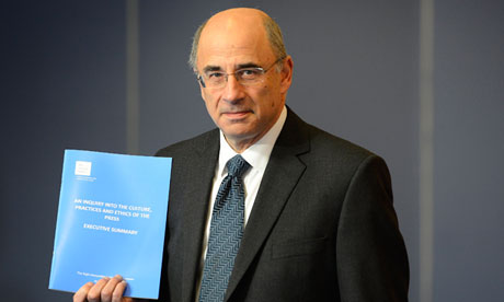 Sir Brian Leveson displaying Kate McCann's autograph