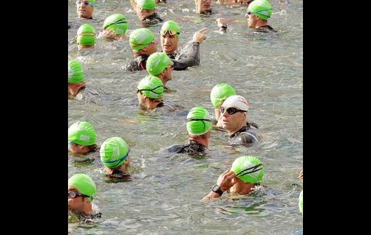 Gerry McCann (wearing white cap) waits with other swimmers to start the 1500 metre swim for the Virgin Active London Triathlon