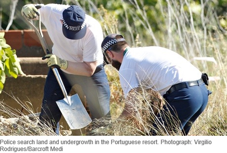 Police search land and undergrowth in the Portuguese resort. Photograph: Virgilio Rodrigues/Barcroft Medi