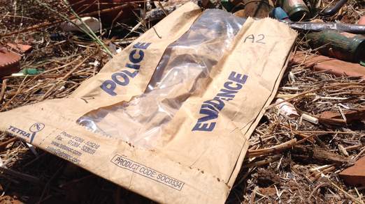A discarded police bag on scrubland where searches finished at the weekend