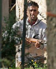 Marques brandishes an air rifle to keep reporters off his land