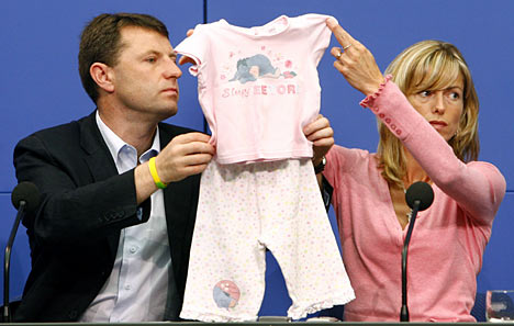 The McCanns hold up a set of pyjamas similar to those worn by Madeleine