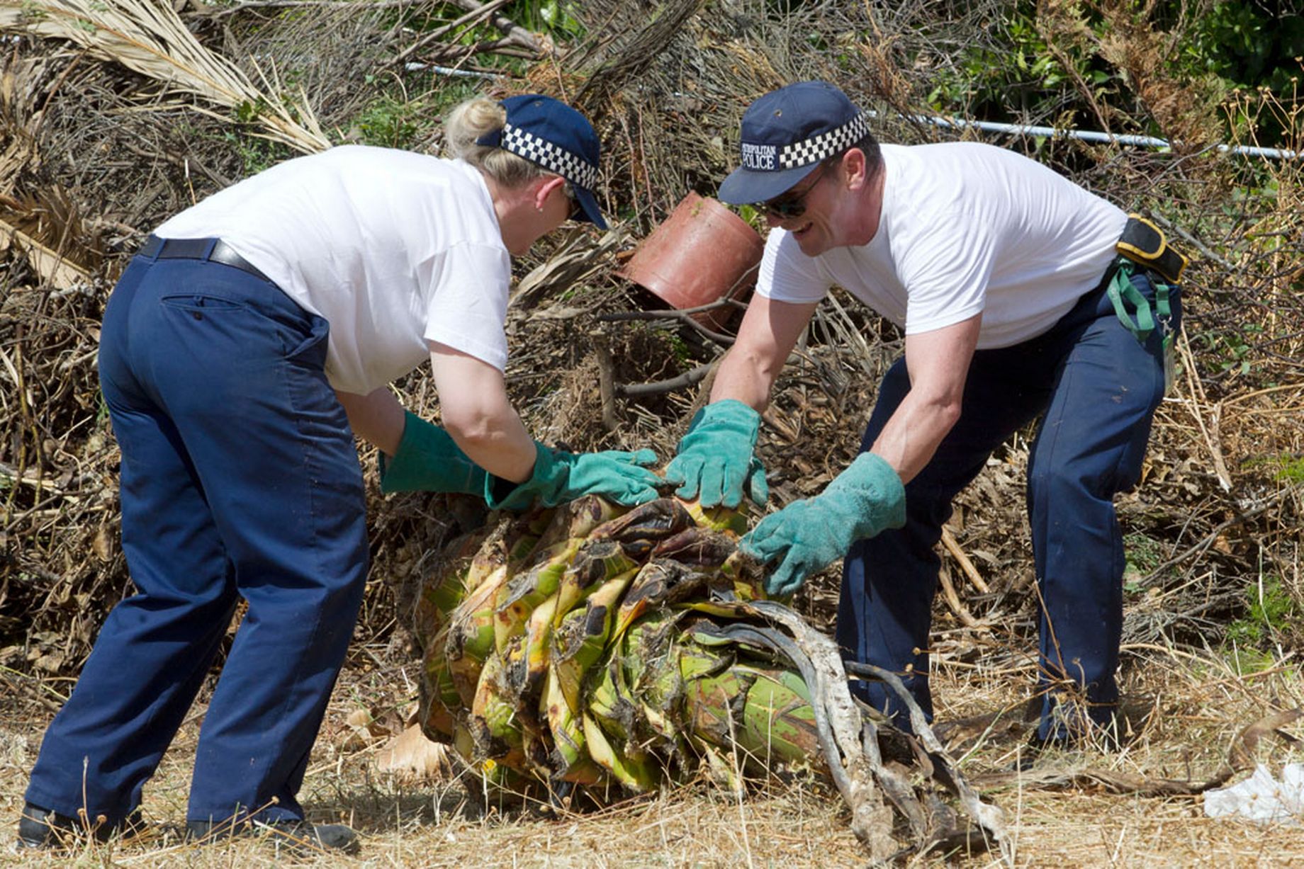 British police officers search the grounds in Praia da Luz in the hope of finding clues
