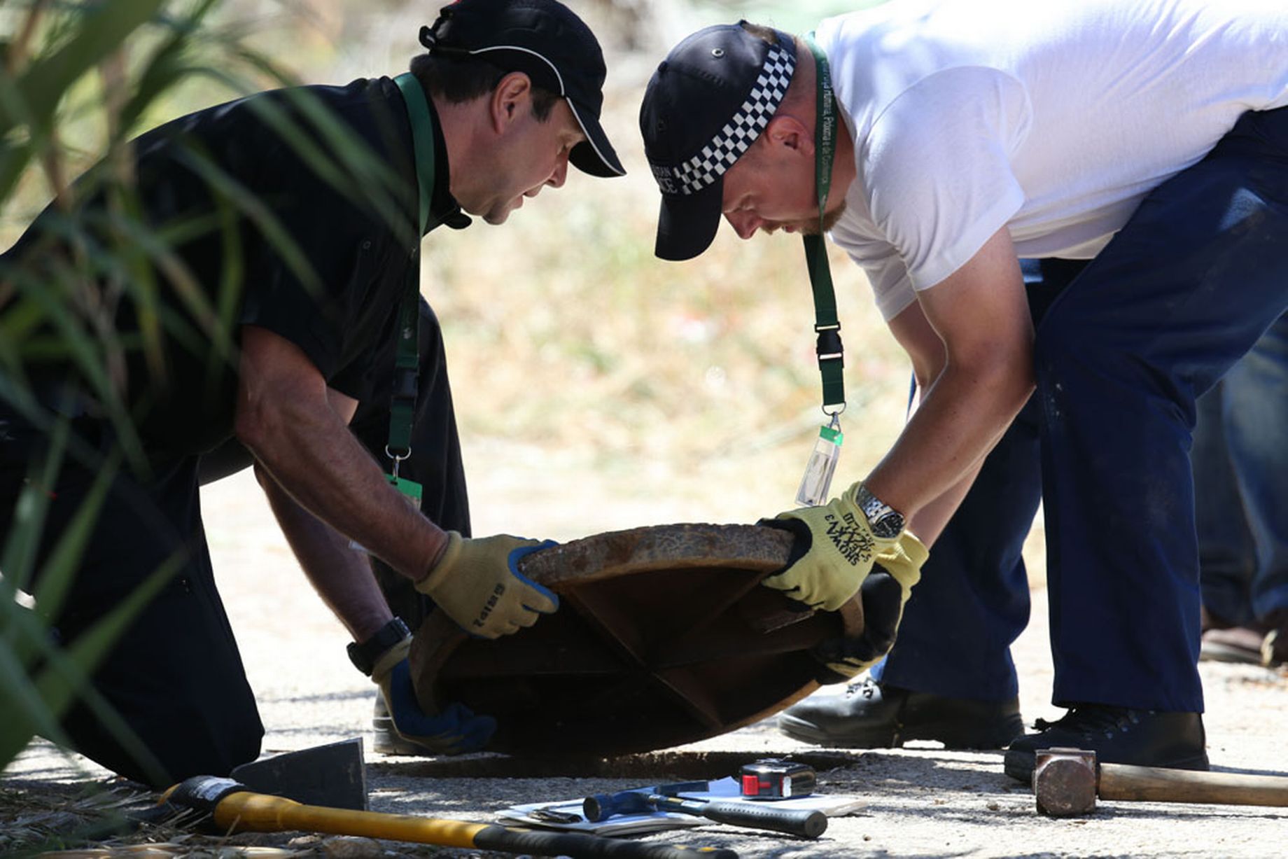 British police use cameras to look down manhole covers as part of new searches in Praia da Luz