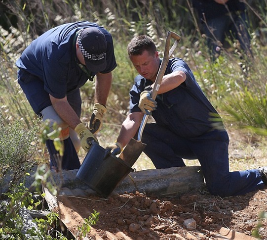 Mystery: British police shift through soil on an area of wasteland during a search for Madeleine McCann in Praia da Luz, Portugal, in June last year during their investigation into her disappearance