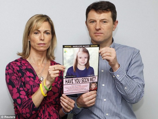 Praying for news: Kate and Gerry McCann are seen posing with a computer generated image of how Maddie might have looked five years after her disappearance