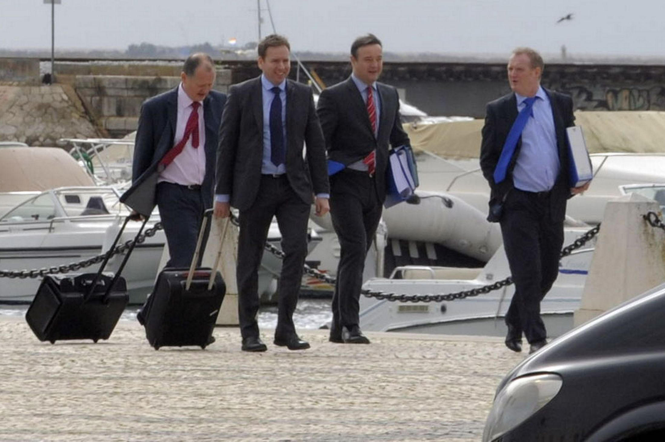 Four British Police officers from Scotland Yard, including DCI Andy Redwood, arrive in downtown Faro carrying documents believed to be relating to the arrest of 3 men in connection with the Madeline McCann case