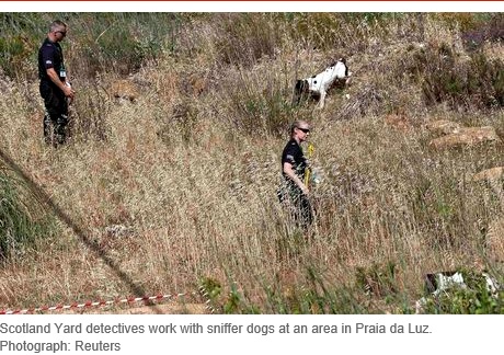 Scotland Yard detectives work with sniffer dogs at an area in Praia da Luz. Photograph: Reuters