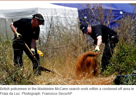 British policemen in the Madeleine McCann search work within a cordoned-off area in Praia da Luz. Photograph: Francisco Seco/AP