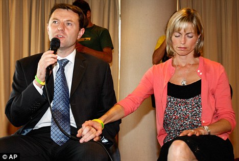 United front: Kate McCann holds husband Gerry's hand during a news conference in Lisbon yesterday