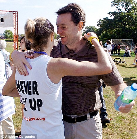 Welcome back: Gerry McCann welcomes his wife Kate McCann at the finish line