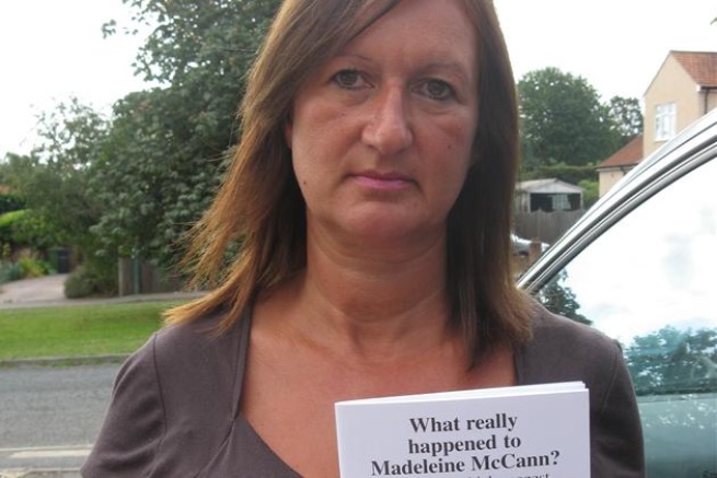 Deborah Butler with a leaflet headed 'What really happened to Madeleine McCann'