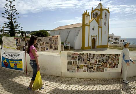 Banners and collages stand outside Praia da Luz's Nossa Senhora da Luz church