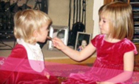 Christmas past: Madeleine feeding her younger sister Amelie in 2006