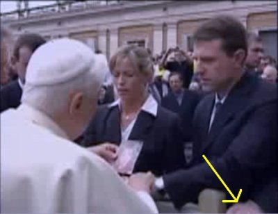 A hand appears on the railing just after the Popes leaves Kate and Gerry Mccann