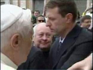 Hand rises quickly as the Pope approaches
