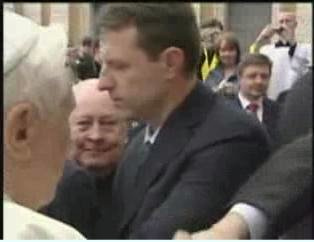 Hand grabs the Popes hand