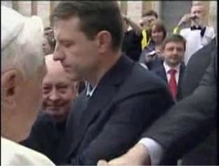 Hand vigourously shakes with the Pope