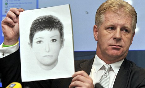 Clarence Mitchell holds up a photofit of the woman police want to speak to regarding Madeleine's disappearance