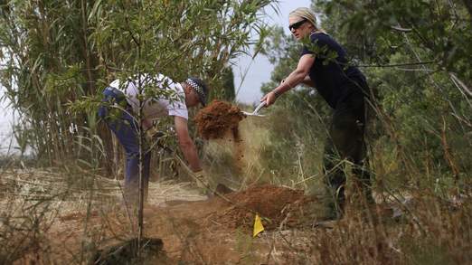 Officers cover a hole dug in the initial search site in Praia da Luz