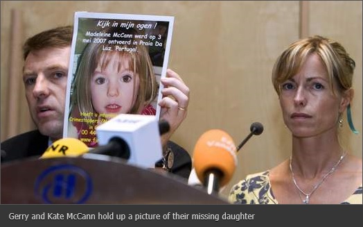 Gerry and Kate McCann hold up a picture of their missing daughter