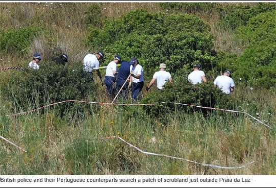 British police and their Portuguese counterparts search a patch of scrubland just outside Praia da Luz Photo: Nick Ansell/PA