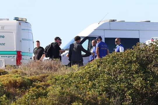 British police meet local police at an area of scrubland close to where Madeleine McCann went missing seven years ago, in the resort of Praia da Luz, Portugal.