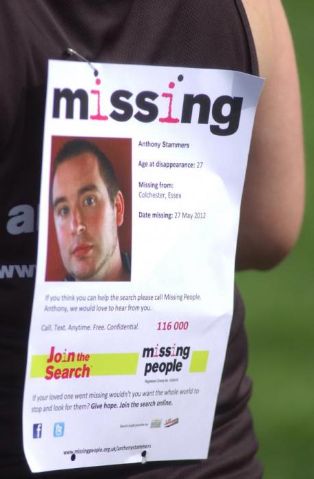 A runner carrying an appeal for missing Anthony Stammers, 27
